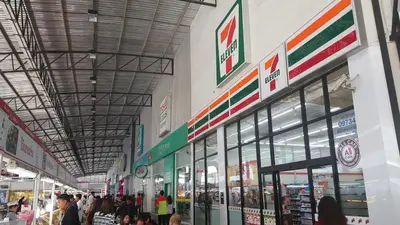 a group of people walking around a shopping mall at Popular Condo C5 IMPACT in Pak Kret