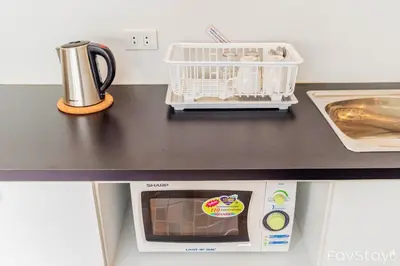 a kitchen counter with a toaster and a dishwasher at Popular Condo C5 IMPACT in Pak Kret