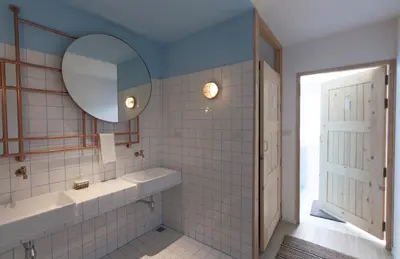 a bathroom with a sink and a mirror at Pinto Hostel in Bangkok