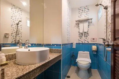 a bathroom with a sink and a toilet at 24@Home Hotel in Nonthaburi