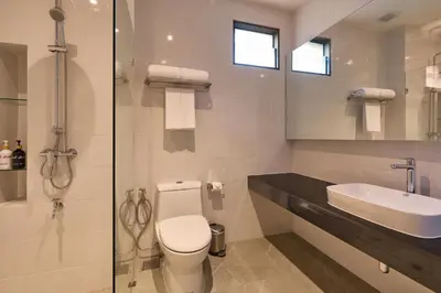 a bathroom with a toilet and a sink and a shower at Red Door Samsen Hotel, Bangkok in Bangkok