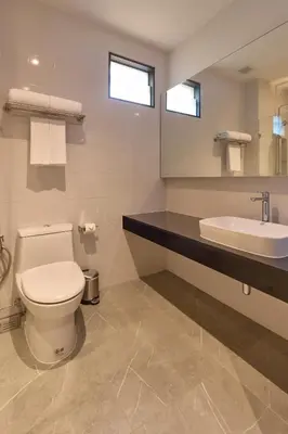 a bathroom with a toilet and a sink at Red Door Samsen Hotel, Bangkok in Bangkok