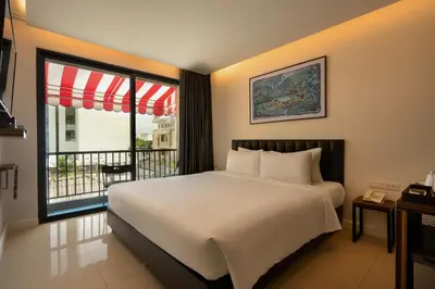 a bedroom with a large bed and a balcony at Red Door Samsen Hotel, Bangkok in Bangkok