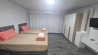 a small room with two beds and a sink at New Room in Nonthaburi