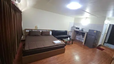 a living room with a bed and a couch at New Room in Nonthaburi