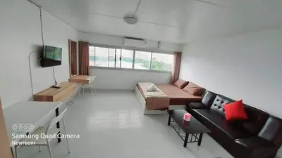 a living room with a couch and a table at New Room in Nonthaburi