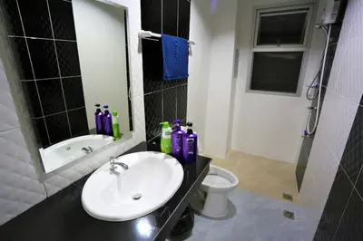 a bathroom with a sink and a toilet at TD Bangkok in Bangkok