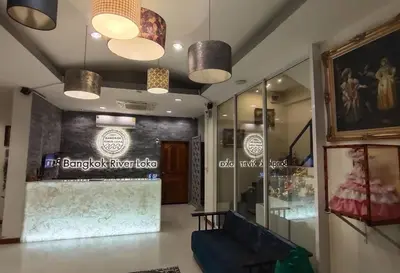 a lobby of a clothing store with two lights at Bangkok River Loka Hotel in Bangkok