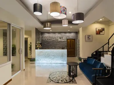 a lobby with a blue couch and a bar at Bangkok River Loka Hotel in Bangkok