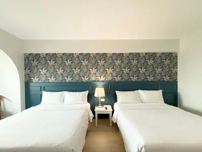 two beds sitting next to each other in a room at Regent Ramkhamhaeng 22 in Bangkok