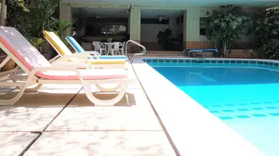 a group of chairs sitting next to a swimming pool at P.T. Court in Bangkok