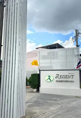 a white building with a rent management sign next to it at Regent Ngamwongwan Hotel in Nonthaburi