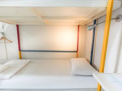 a small bed in a small room at Regent Ngamwongwan Hotel in Nonthaburi