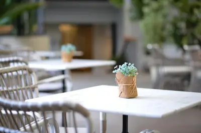 a small flower pot sitting on top of a table at Abloom Exclusive Serviced Apartments in Bangkok