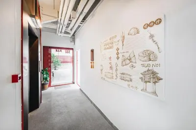a hallway with a wall with drawings on it at Talakkia Boutique Hotel in Bangkok