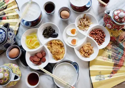 a table with plates of food and bowls of ingredients at Talakkia Boutique Hotel in Bangkok