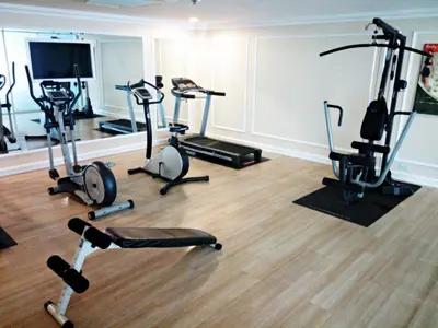 a gym with several exercise bikes in a room at Romance Hotel Bangna in Bangkok