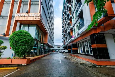 an empty street in a city with tall buildings at PDA Lord Hotel in Bangkok