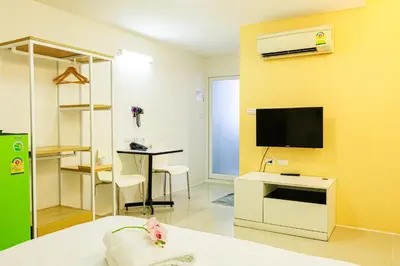 a room with a bed and a tv on a wall at PDA Lord Hotel in Bangkok