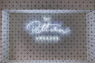 a sign that reads the ashok museum on a white tiled wall at The Pattern Boutique Hotel in Bangkok