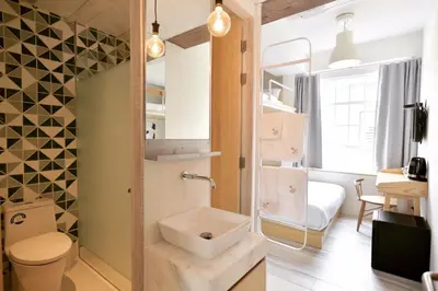 a small bathroom with a sink and a toilet at The Pattern Boutique Hotel in Bangkok