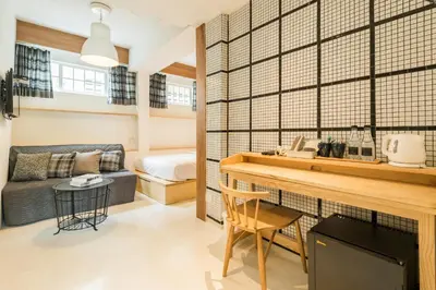 a living room with a couch and a table at The Pattern Boutique Hotel in Bangkok