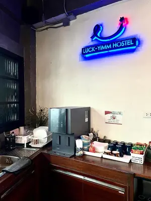 a kitchen counter with a microwave on top of it at Luck Yimm Hostel in Bangkok
