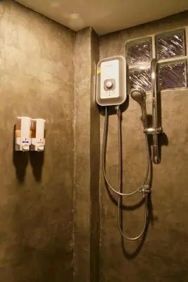 a shower in a bathroom with a shower at Luck Yimm Hostel in Bangkok