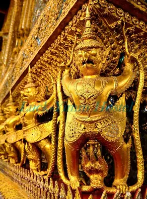 a gold statue of a deity on a building at Luck Yimm Hostel in Bangkok