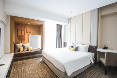 a hotel room with a bed and a desk at twothree a homely hotel - SHA Extra Plus in Bangkok