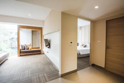 a hotel room with a hallway with a bedroom at twothree a homely hotel - SHA Extra Plus in Bangkok