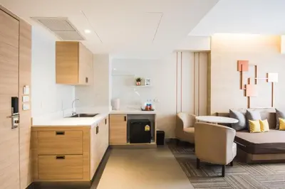 a kitchen with a sink and a table in a room at twothree a homely hotel - SHA Extra Plus in Bangkok