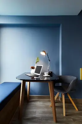 a desk with a laptop and a chair in a room at The Quarter Ladprao by UHG in Bangkok