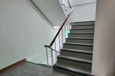 a staircase in a building with a stair case at Ease Hostel in Bangkok