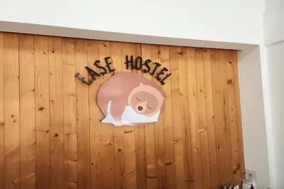 a wall with a sign that reads use house at Ease Hostel in Bangkok