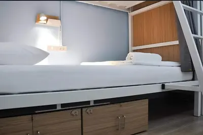 a bedroom with a bunk bed and a ladder at Ease Hostel in Bangkok