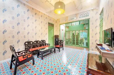 a room with three benches in a room with wallpaper at Ama Hostel Bangkok in Bangkok