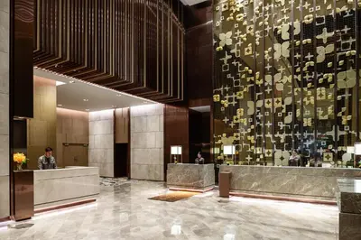 a lobby of a hotel with a wall filled with notes at Hotel Nikko Bangkok in Bangkok