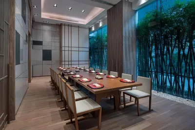 a long dining room with a long table and chairs at Hotel Nikko Bangkok in Bangkok