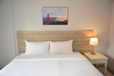 a bedroom with a white bed and a red bridge at Drop Inn Bangkok in Bangkok