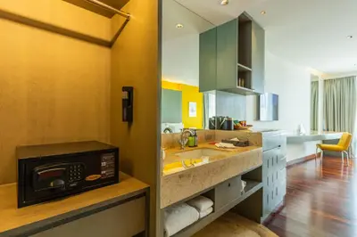 a kitchen with a sink and a microwave at LiT BANGKOK Hotel in Bangkok