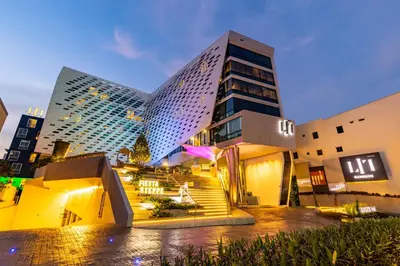 a hotel with a staircase in front of a building at LiT BANGKOK Hotel in Bangkok