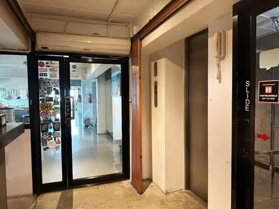 an entrance to a store with glass doors at Jam Hostel Bangkok in Bangkok