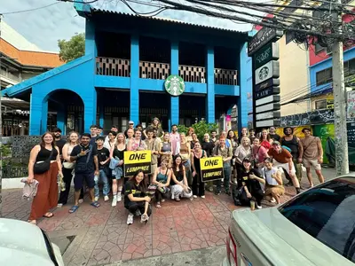 a group of people holding up signs in front of a building at Jam Hostel Bangkok in Bangkok