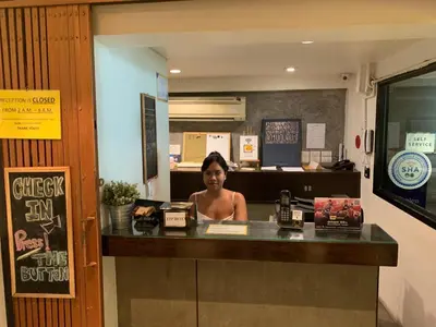 a woman sitting at a counter in a restaurant at Jam Hostel Bangkok in Bangkok