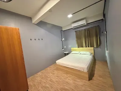a small bedroom with a bed and a window at Arun Old Town in Bangkok