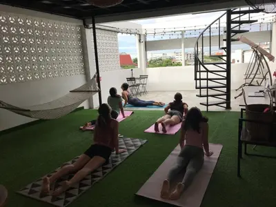 a group of people sitting in a yoga class at Arun Old Town in Bangkok
