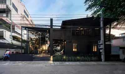 a building on a street with a building at Kloem Hostel in Bangkok