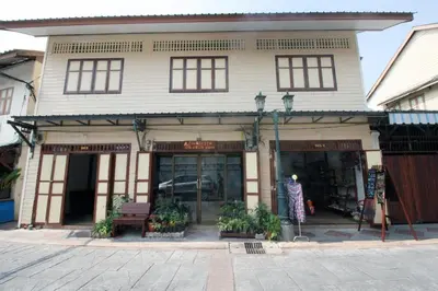 a store front of a building with a woman standing outside at OB ARUN House in Bangkok