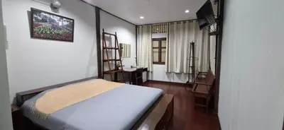 a bedroom with a bed and a desk in it at OB ARUN House in Bangkok